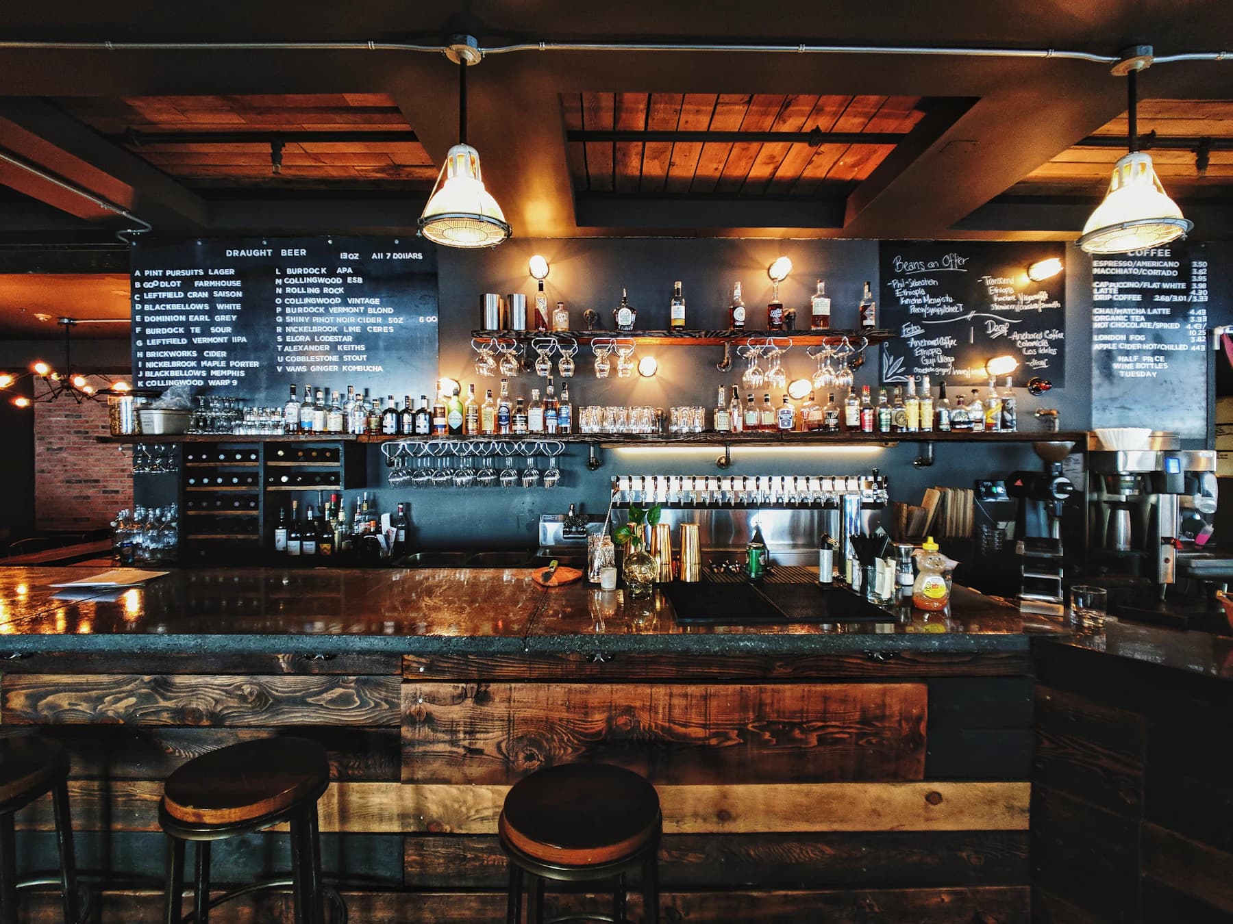 The bar: backlit shelves of bottles above a dark timber counter.